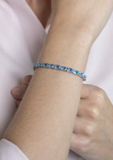 Five Stones Bracelet Blue Topaz 6X4 — bracelet worn, close-up: sterling silver with five natural blue topaz stones